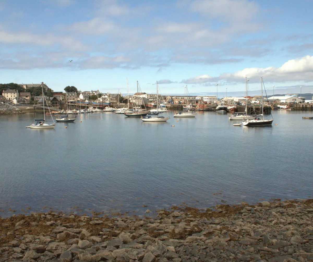 The harbour and fishing boats of Mallaig at the end of the Road to the Isles, a coastal stop on the 3-day Isle of Skye and Highlands tour in the Scottish Highlands